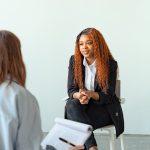Therapist interacting with client during a counseling session indoors.